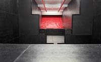 Indoor shooting range with red bullet trap and black barricade