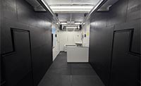 Forward view of an indoor shooting range with black soundproof walls