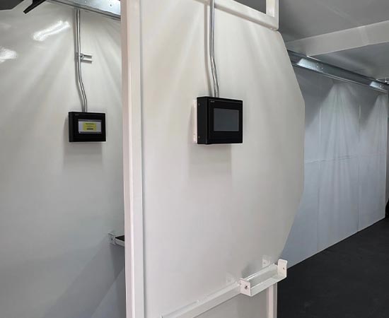 Mobile shooting range container showing two adjacent white metal shooting stalls