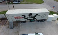 White shipping container featuring black pistol aiming figures