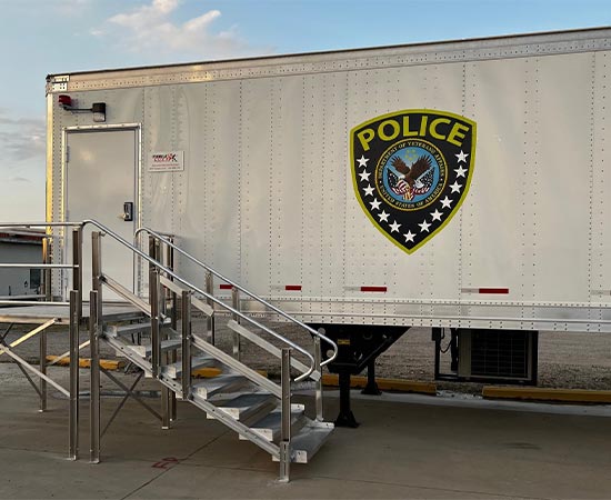 White mobile container structure labeled police badge of US Department of Veterans Affairs